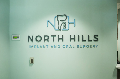 Logo of North Hills Implant & Oral Surgery -  Eric Hoverst displayed in the wall.