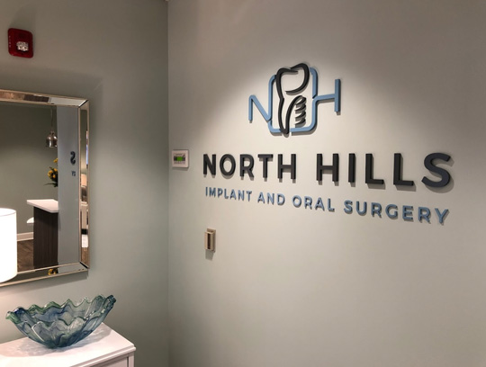 Logo sign at North Hills Implant & Oral Surgery in Raleigh, NC.