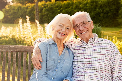 An elderly couple smiling at North Hills Implant & Oral Surgery in Raleigh, NC
